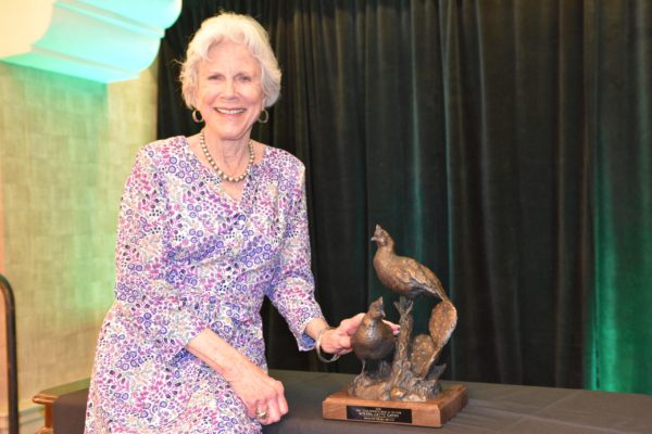 Roxie Hayne with her bronze statue of quail, in honor of her dedication to conservation in West Texas.